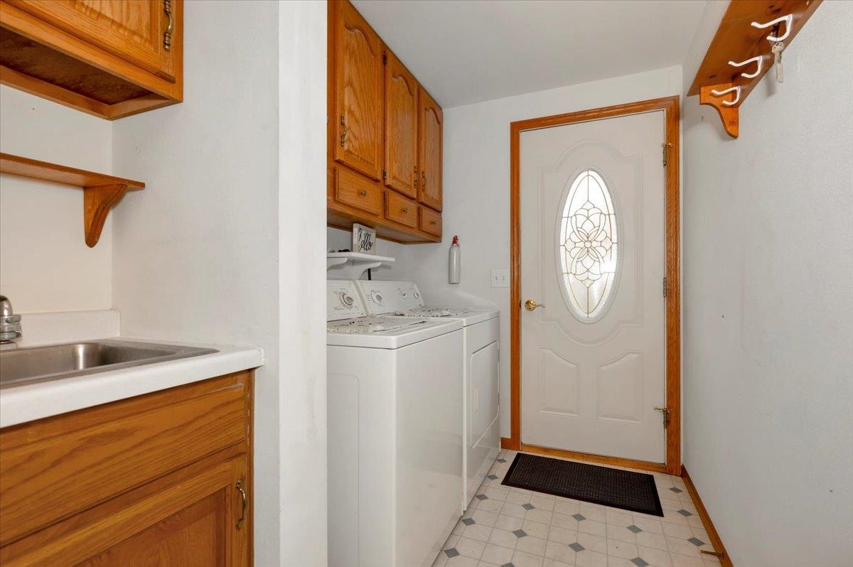 6373 Maple Grove Road Cloquet, MN 55720 - Photo 6 of 42 Washroom featuring cabinet space, washing machine and clothes dryer, and light floors