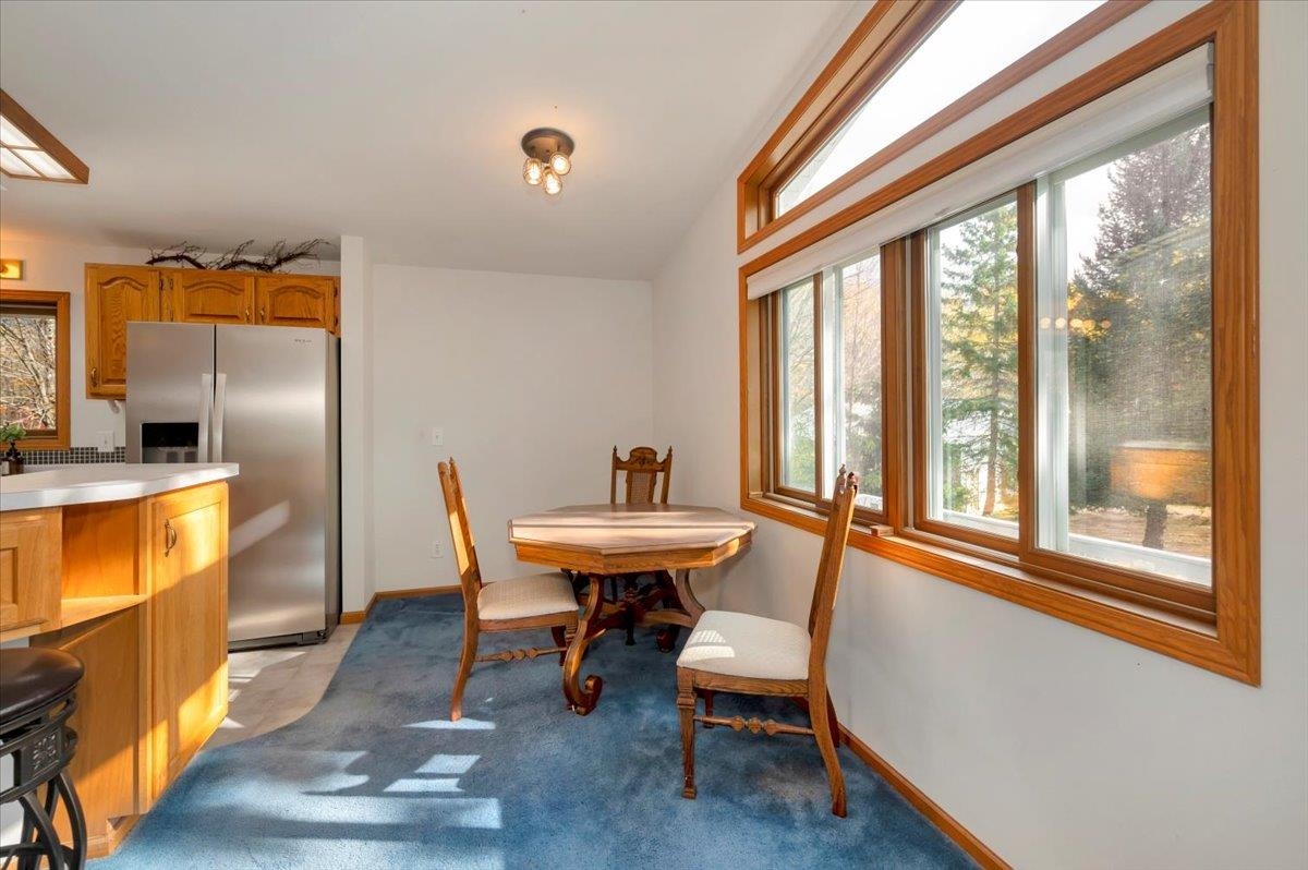 6373 Maple Grove Road Cloquet, MN 55720 - Photo 10 of 42 Dining area featuring light carpet and baseboards