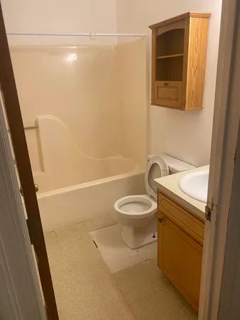 a bathroom with a toilet and a shower