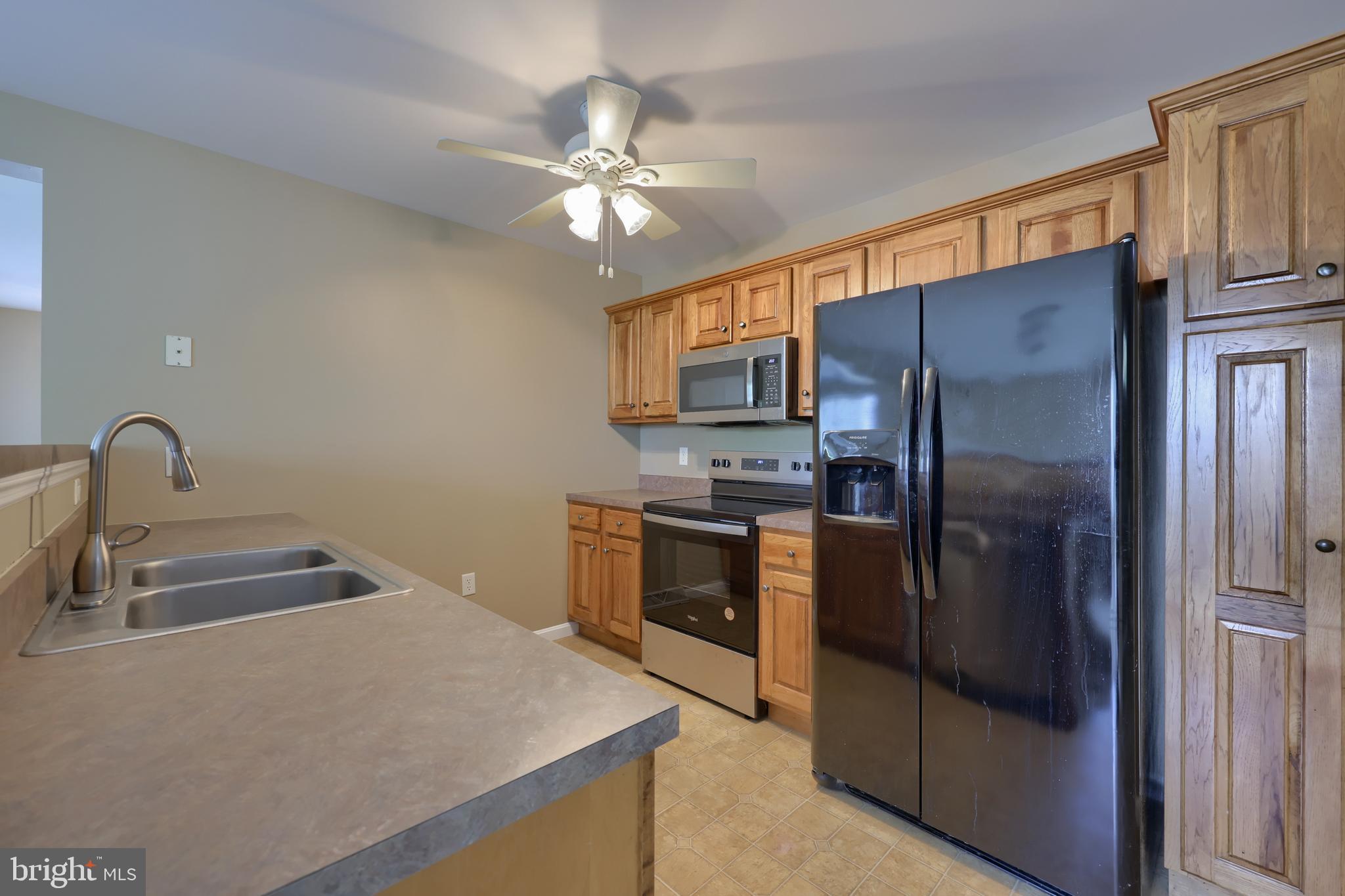 619 Chatham Way Lititz, PA 17543 - Photo 12 of 32 a kitchen with stainless steel appliances granite countertop a refrigerator a stove a sink and dishwasher