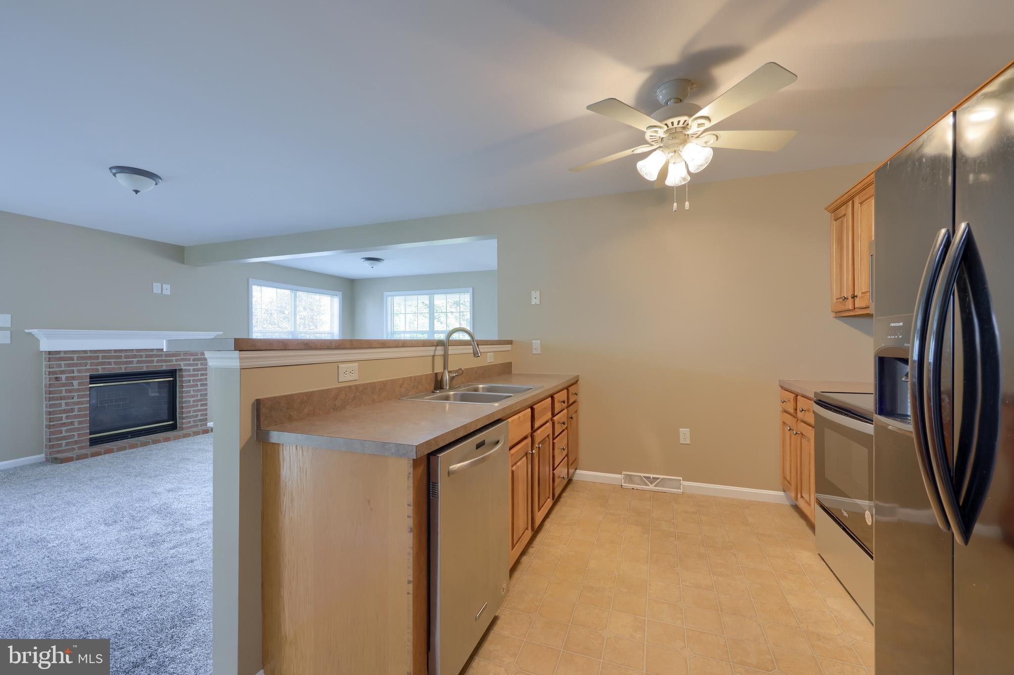 619 Chatham Way Lititz, PA 17543 - Photo 13 of 32 a kitchen with stainless steel appliances granite countertop a sink and a refrigerator