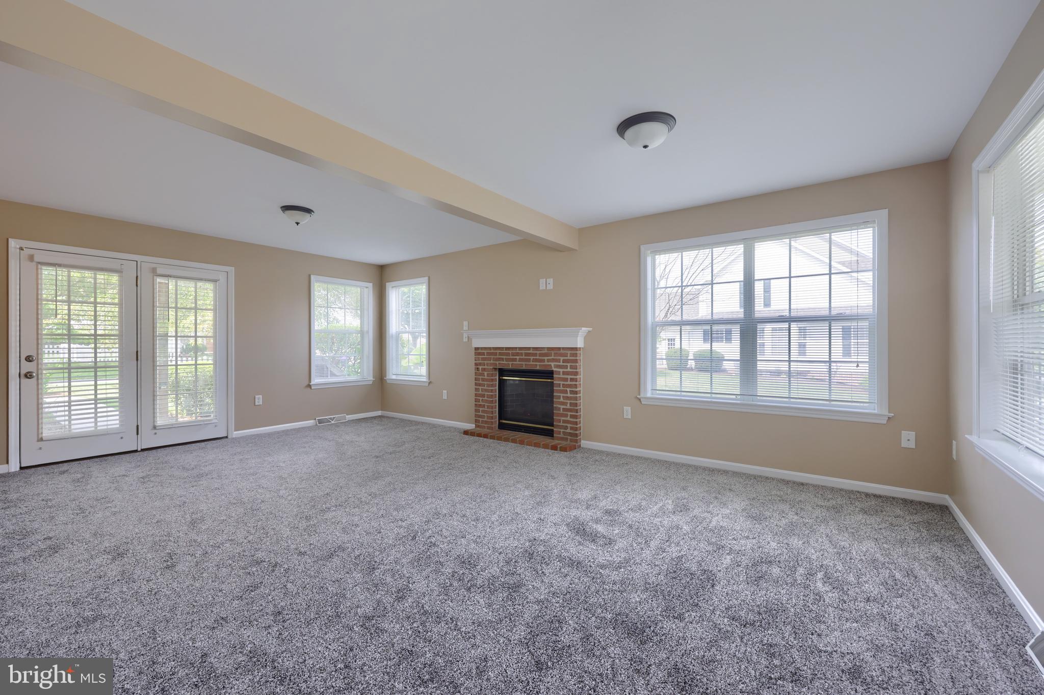 619 Chatham Way Lititz, PA 17543 - Photo 8 of 32 a view of empty room with a fireplace and windows