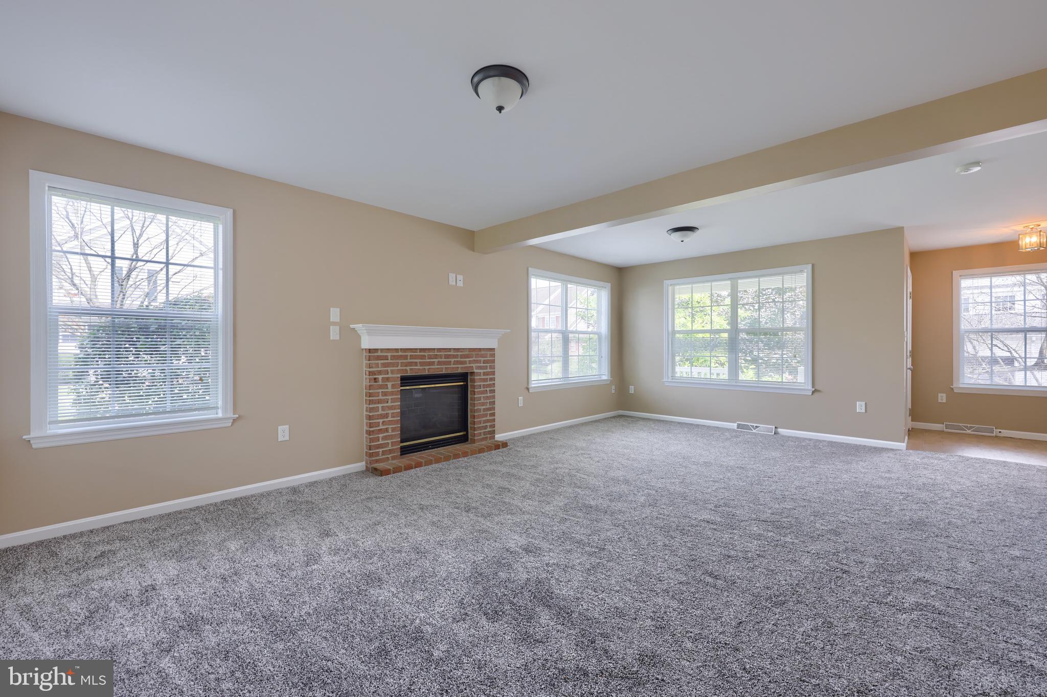 619 Chatham Way Lititz, PA 17543 - Photo 9 of 32 an empty room with windows and fireplace