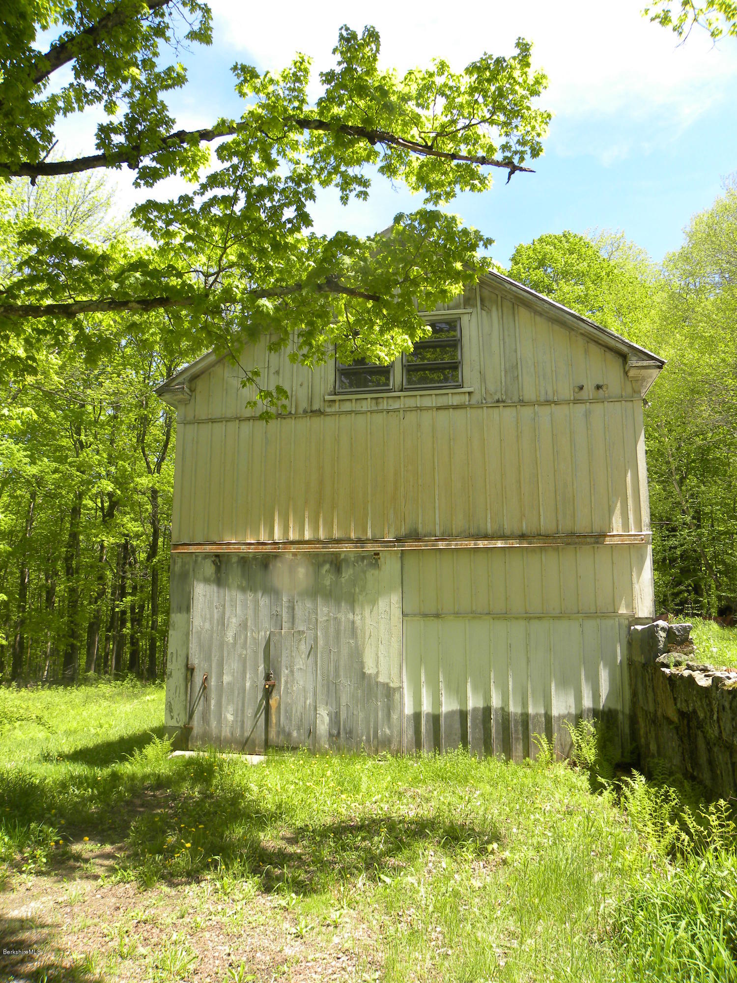 51 Norfolk Road Sandisfield, MA 01255 - Photo 6 of 11 a backyard of a house with lots of green space and plants