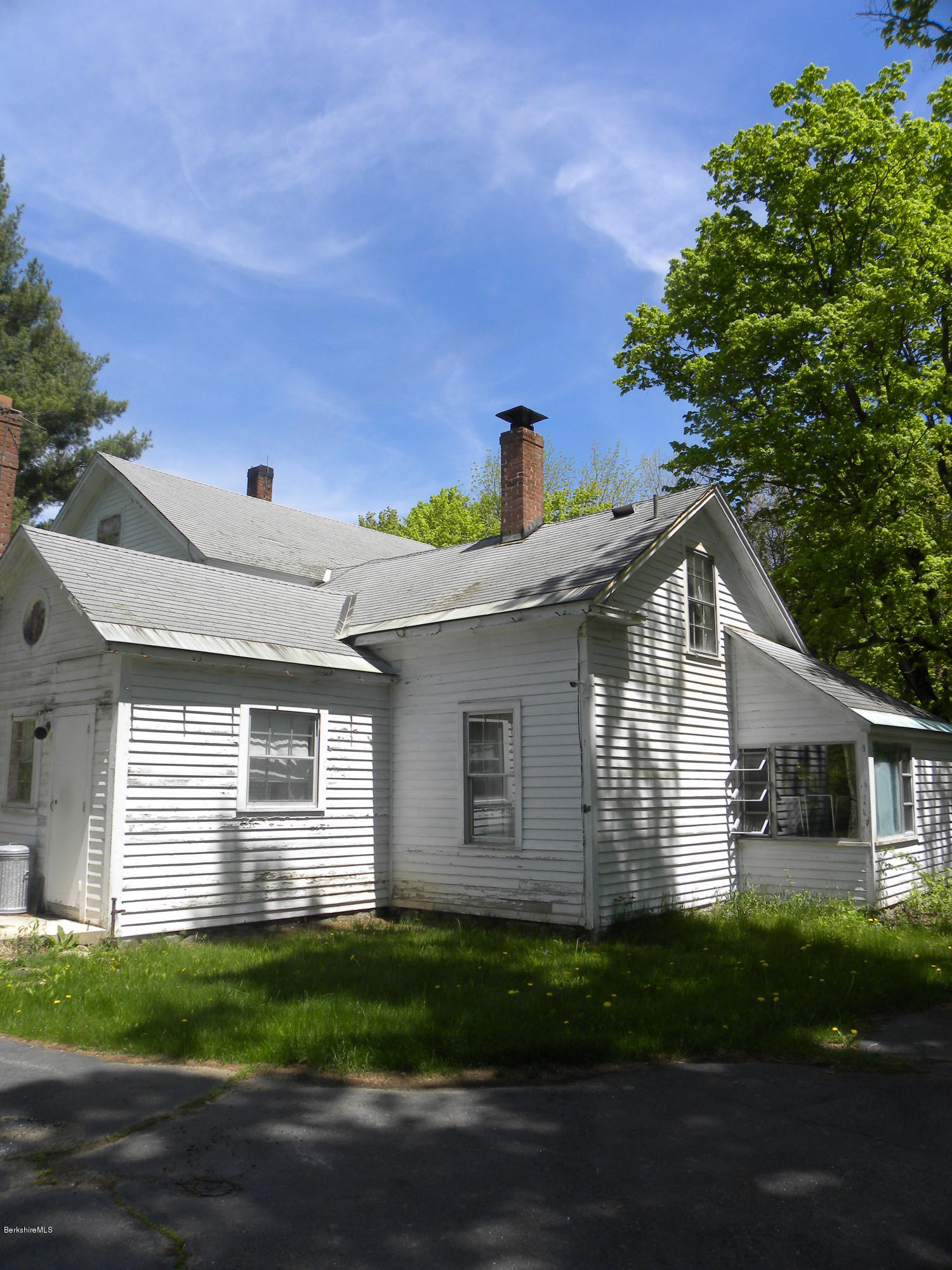 51 Norfolk Road Sandisfield, MA 01255 - Photo 8 of 11 a front view of a house with a yard and a garage