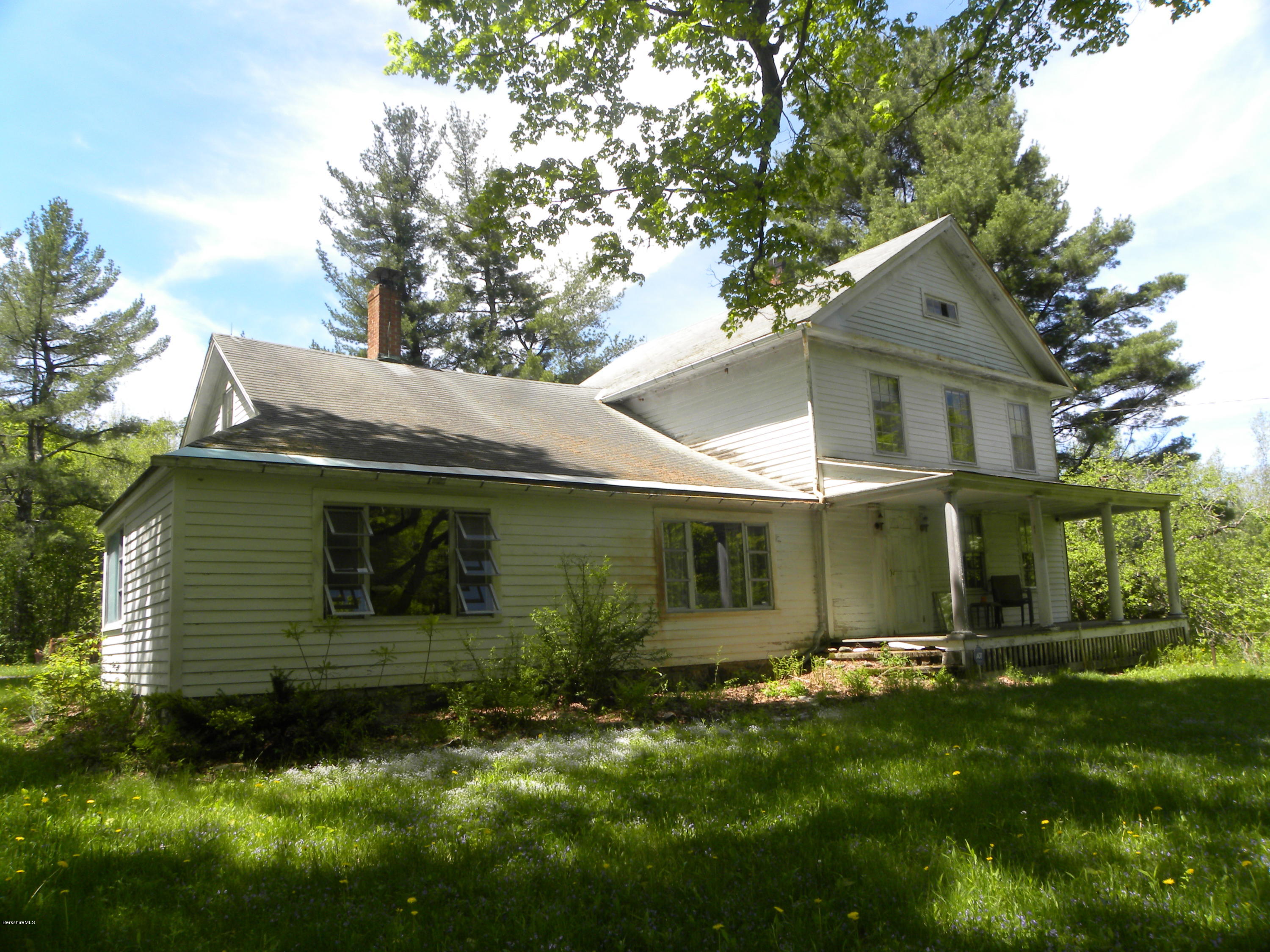 51 Norfolk Road Sandisfield, MA 01255 - Photo 10 of 11 a front view of a house with a garden and yard