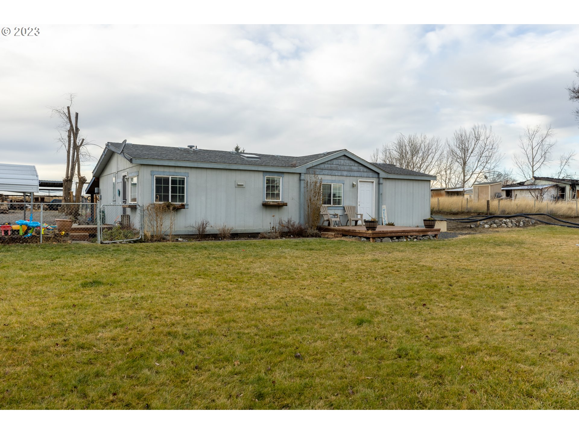 78390 Agnew Road Hermiston, OR 97838 - Photo 1 of 27 a view of a house with a big yard and large trees