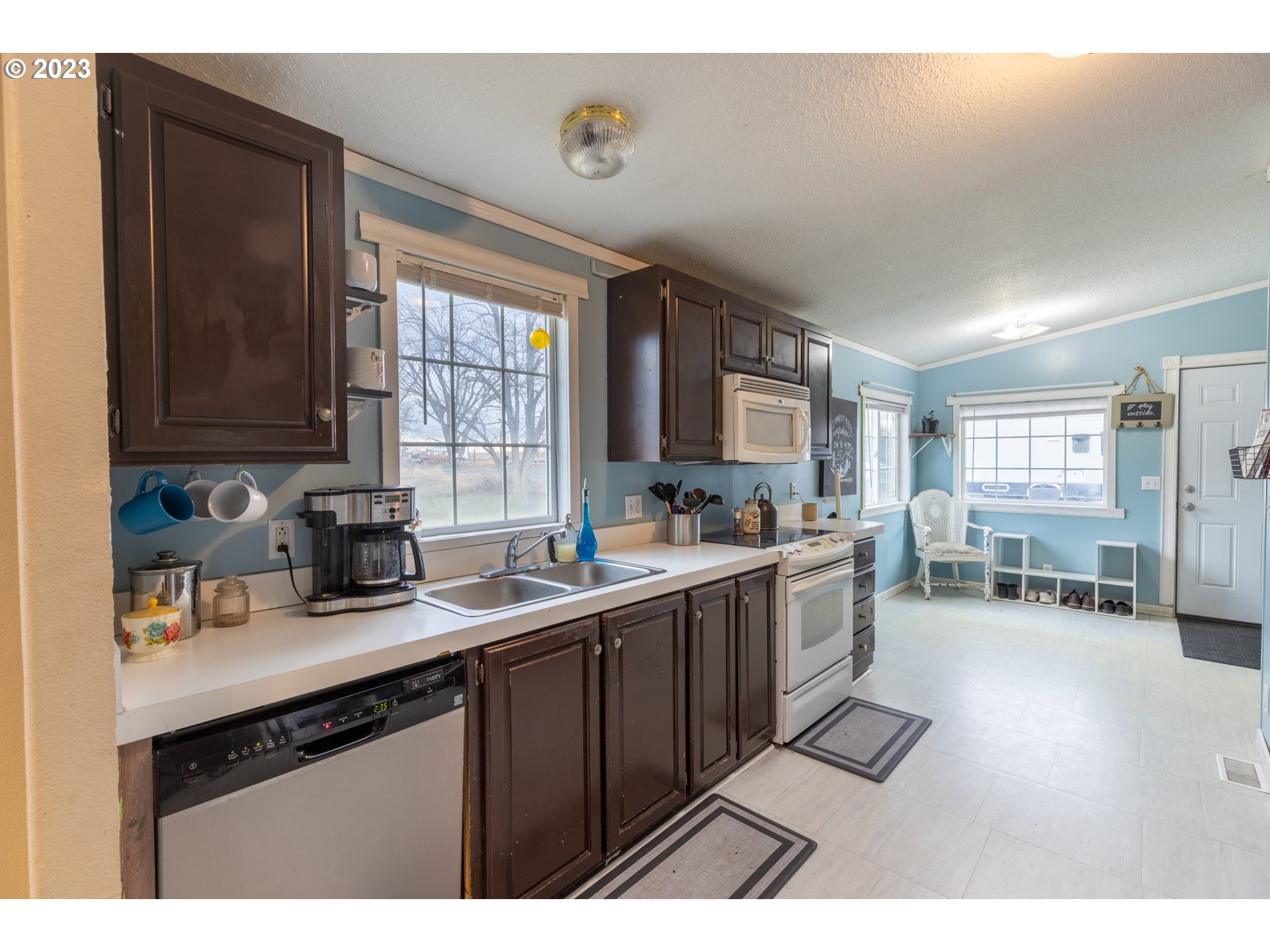 78390 Agnew Road Hermiston, OR 97838 - Photo 13 of 27 a kitchen with a sink a stove and cabinets
