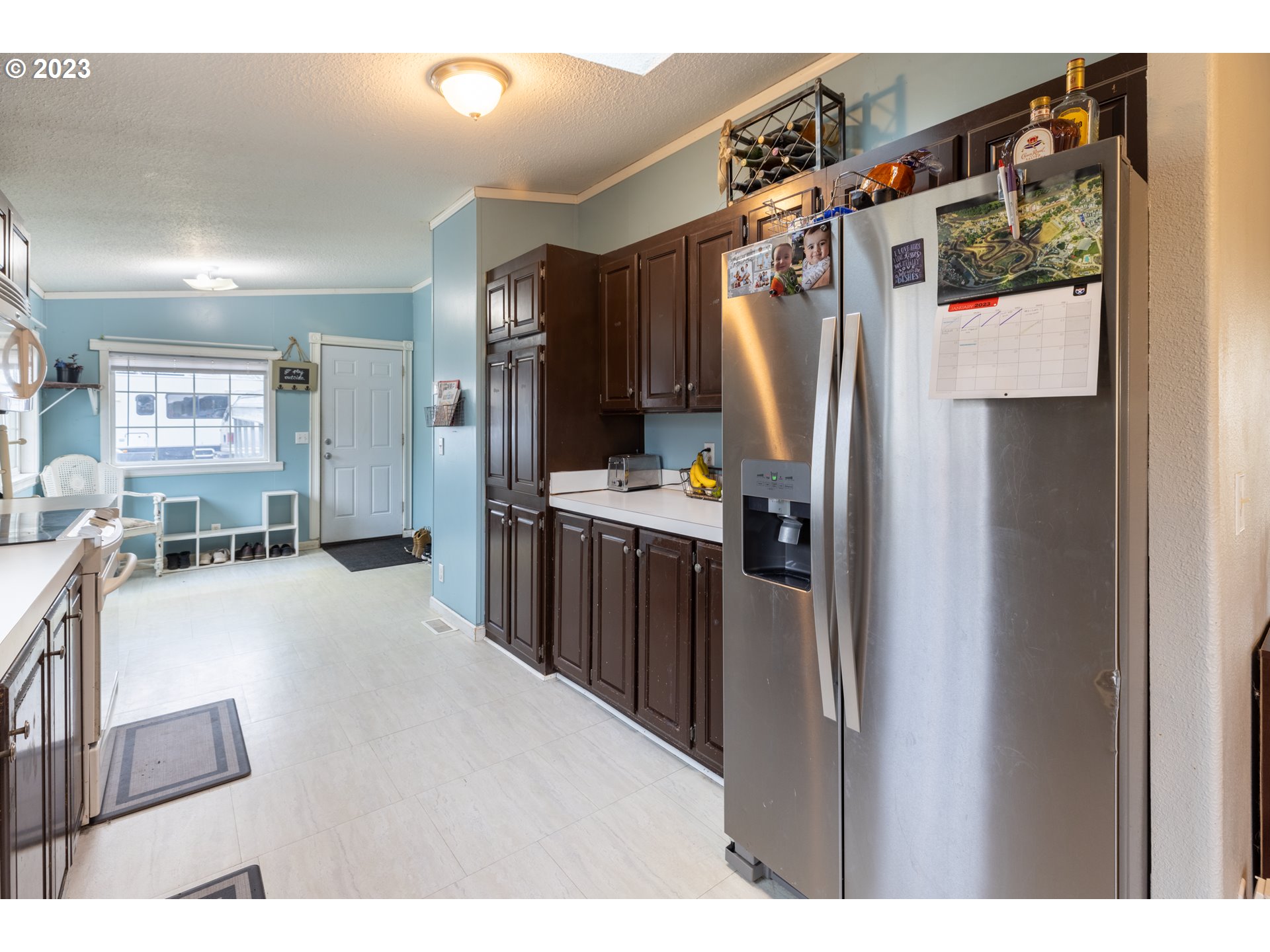 78390 Agnew Road Hermiston, OR 97838 - Photo 14 of 27 a kitchen with stainless steel appliances kitchen island a refrigerator and a counter