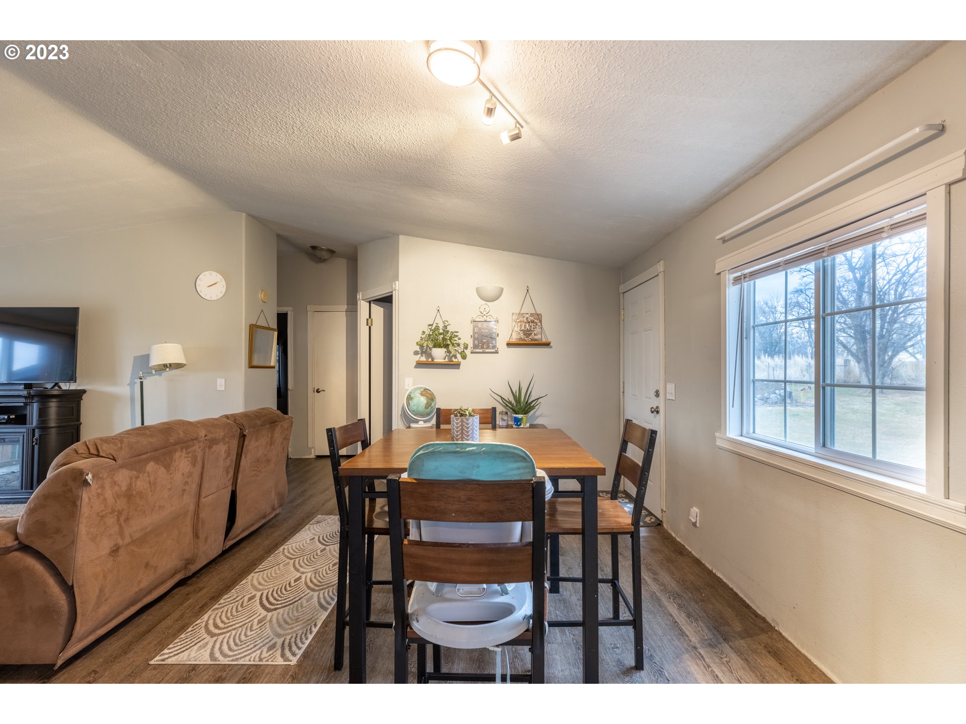 78390 Agnew Road Hermiston, OR 97838 - Photo 15 of 27 a view of a dining room with furniture window and wooden floor