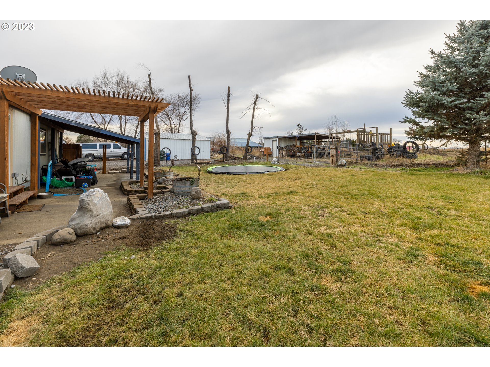 78390 Agnew Road Hermiston, OR 97838 - Photo 8 of 27 a view of a swimming pool with outdoor seating