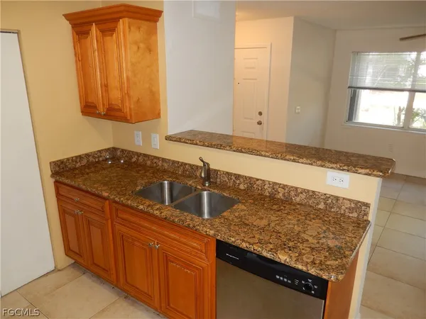 a kitchen with granite countertop a sink and a stove