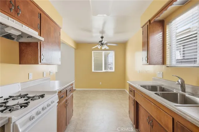 a kitchen that has a sink and a stove