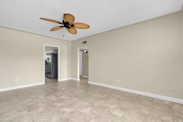 a view of an empty room with window and cabinet