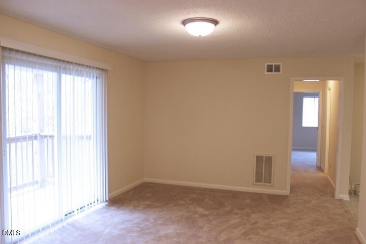 203 East Ransom Street, Unit 3D Fuquay-Varina, NC 27526 - Photo 4 of 10 an empty room with windows