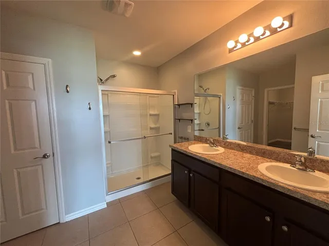 a bathroom with a double vanity sink and a mirror