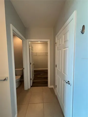 a view of a hallway with a wooden door