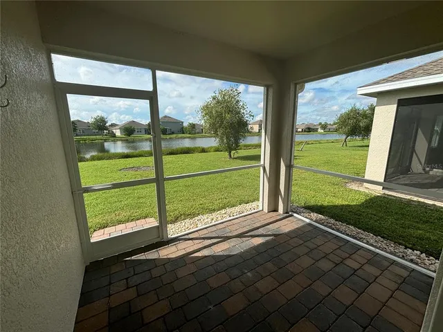 a view of a two room with wooden floor and outdoor space