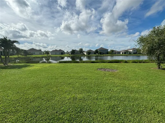 a view of a lake with houses in the background