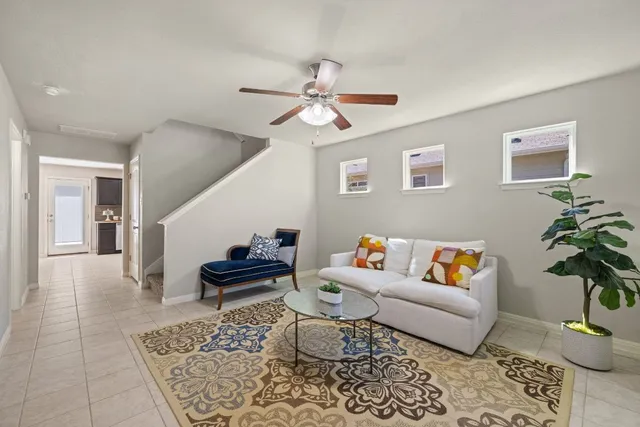 a living room with furniture and wooden floor