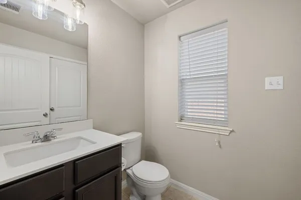 a bathroom with a sink a toilet and a mirror