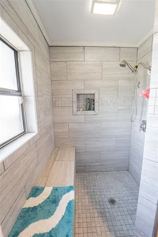 a hallway with white cabinets and wooden floor