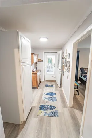 a bedroom with a bed wooden floor and window