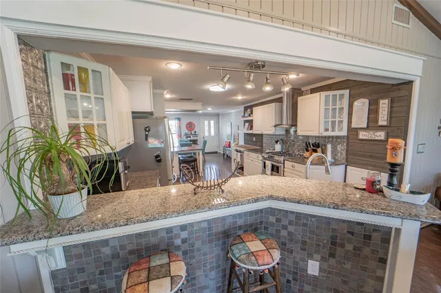 a dining room with furniture and wooden floor