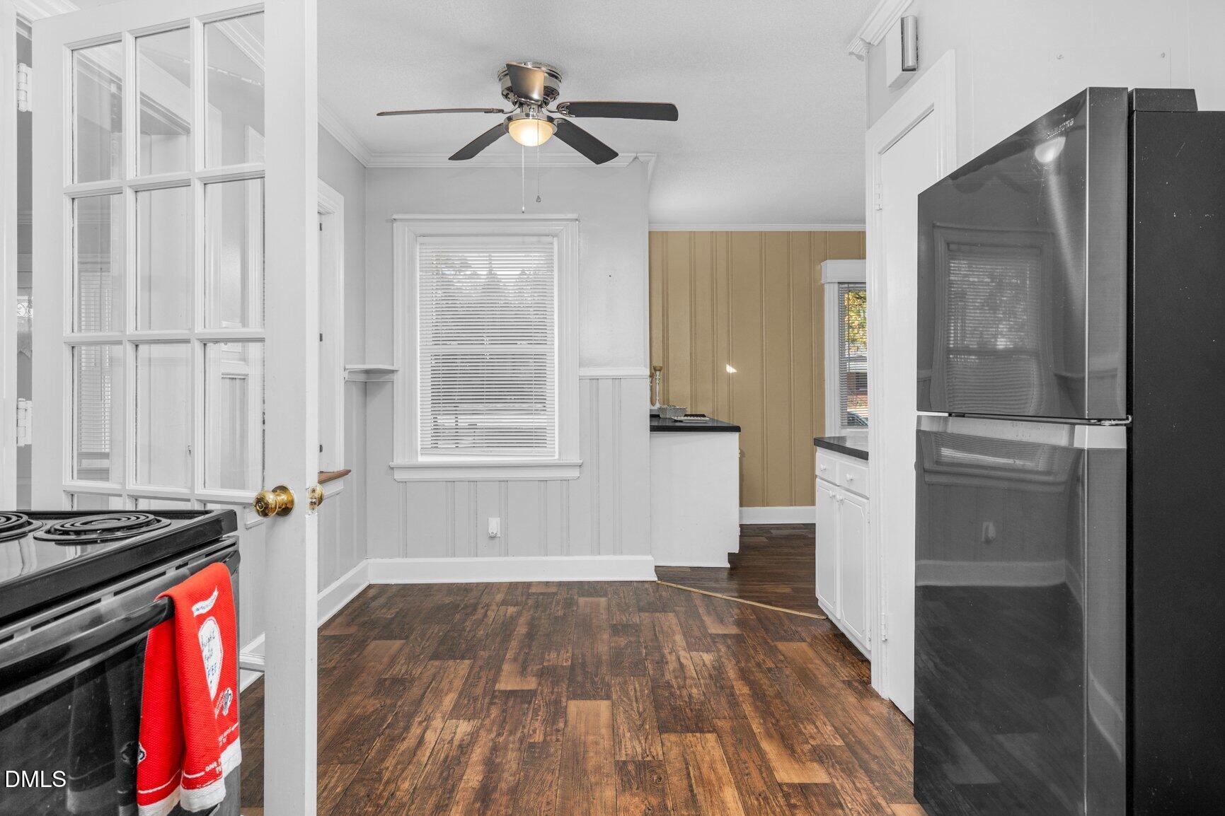 902 Treemont Road Northwest Wilson, NC 27896 - Photo 11 of 43 a view of a kitchen with wooden floor electronic appliances and a ceiling fan
