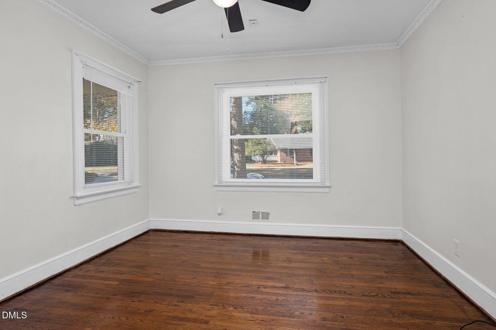 902 Treemont Road Northwest Wilson, NC 27896 - Photo 26 of 43 a view of an empty room with wooden floor and a window