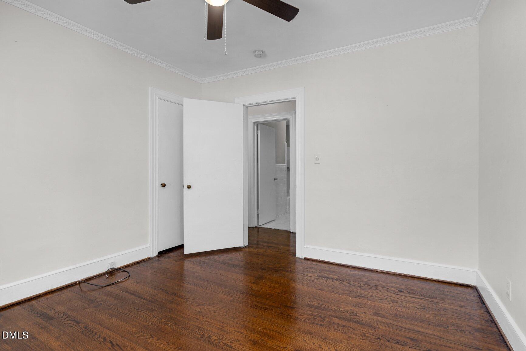902 Treemont Road Northwest Wilson, NC 27896 - Photo 27 of 43 an empty room with wooden floor ceiling fan and window