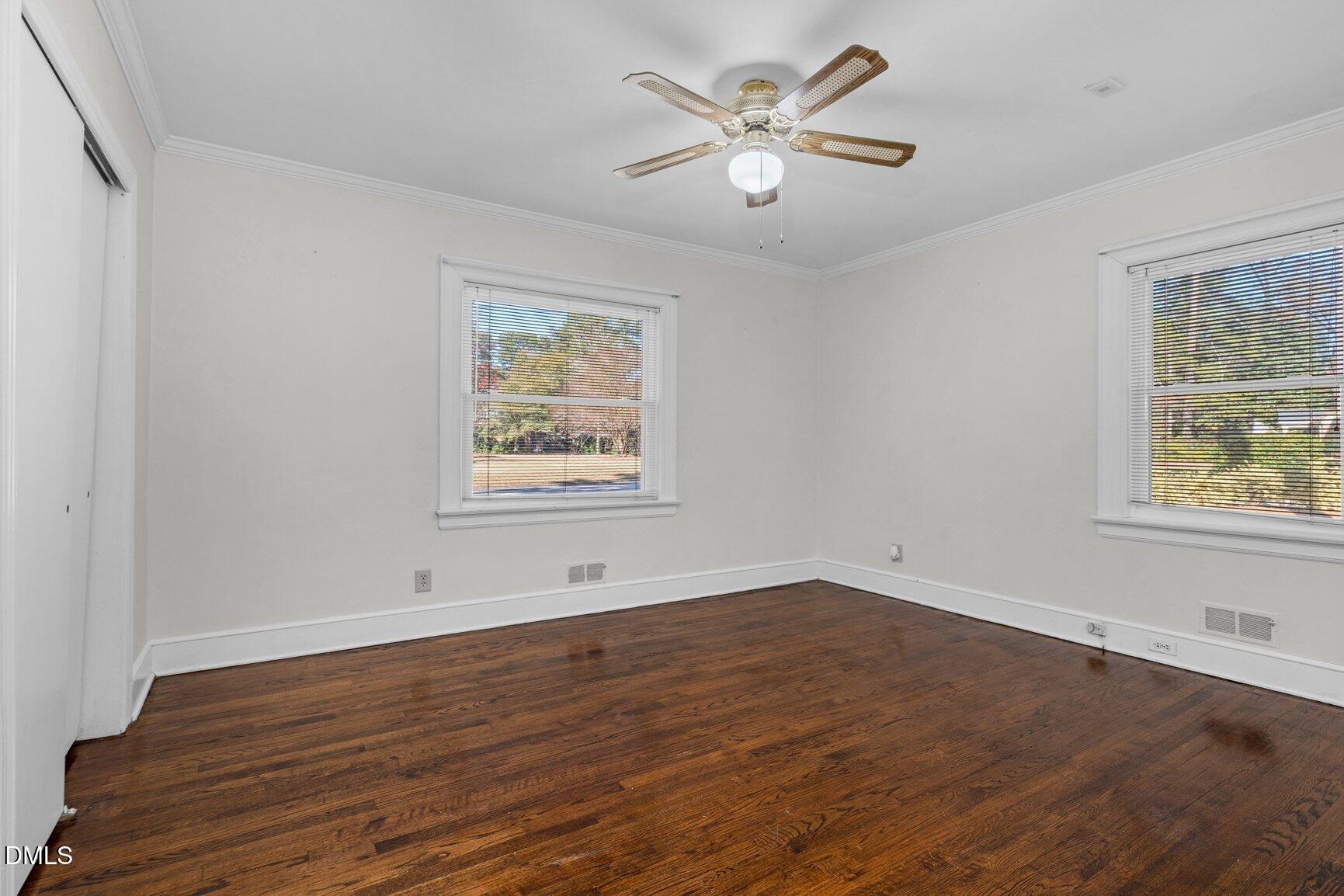 902 Treemont Road Northwest Wilson, NC 27896 - Photo 29 of 43 a view of an empty room with wooden floor and a window