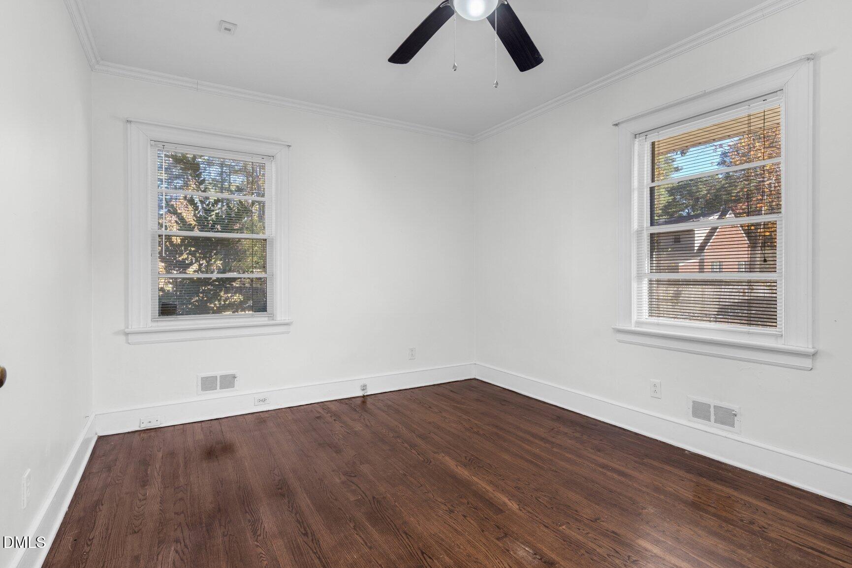 902 Treemont Road Northwest Wilson, NC 27896 - Photo 33 of 43 a view of an empty room with wooden floor and a window