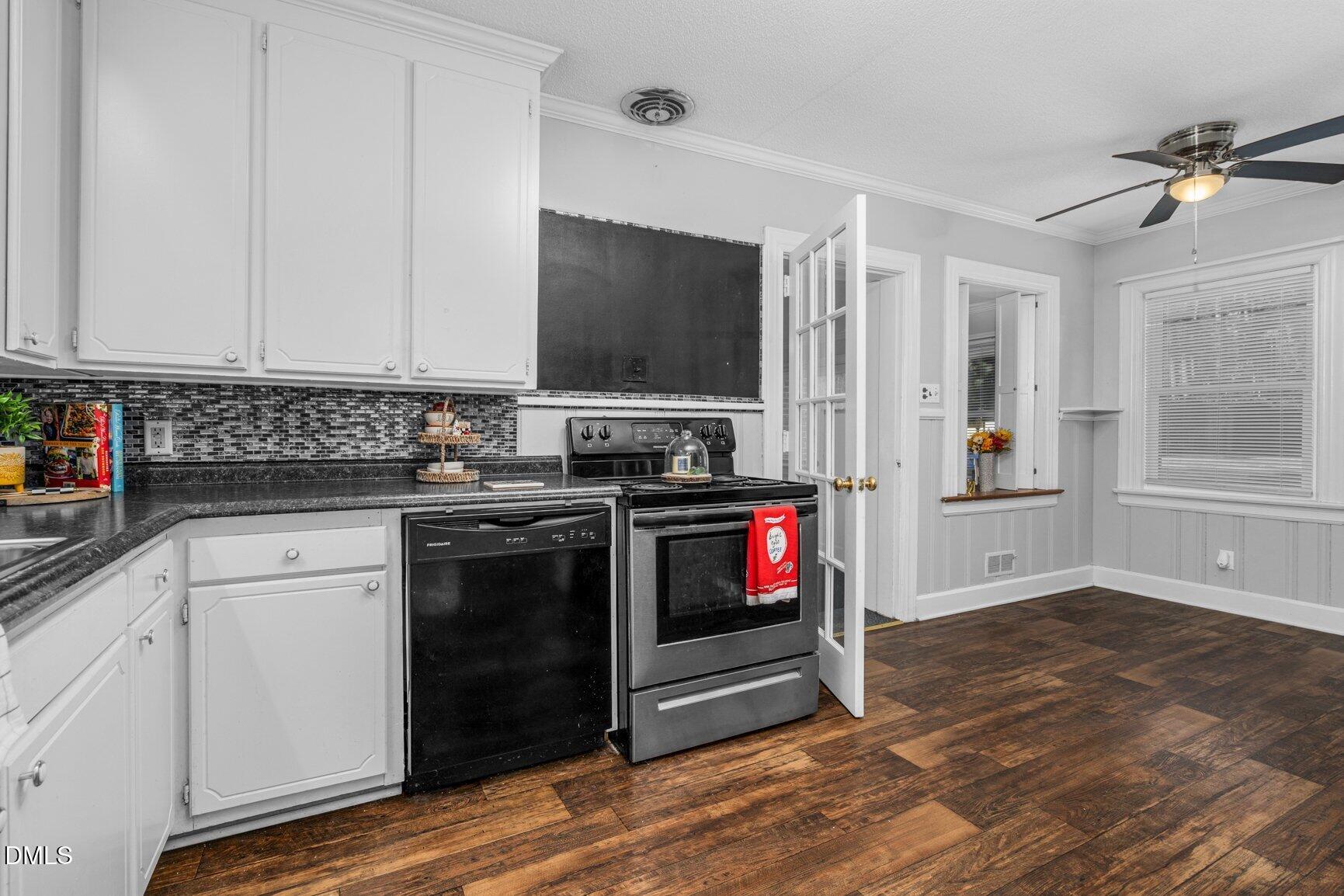 902 Treemont Road Northwest Wilson, NC 27896 - Photo 10 of 43 a kitchen with granite countertop a stove and a wooden floor