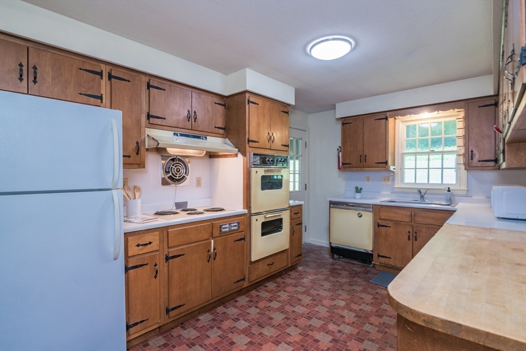 24 South Sunset Avenue Amherst, MA 01002 - Photo 13 of 42 a kitchen with a sink stove and refrigerator