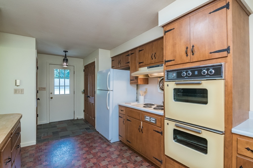 24 South Sunset Avenue Amherst, MA 01002 - Photo 14 of 42 a kitchen with granite countertop white cabinets and white appliances