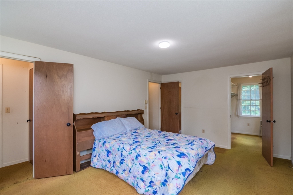 24 South Sunset Avenue Amherst, MA 01002 - Photo 21 of 42 a bedroom with a bed and a cabinets
