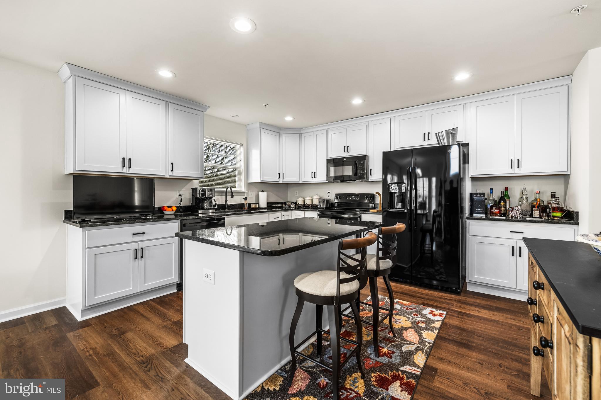 13107 Choptank Road Middle River, MD 21220 - Photo 13 of 42 a kitchen with refrigerator a sink and chairs