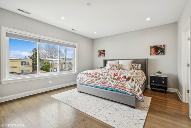a bedroom with a large bed and a large window