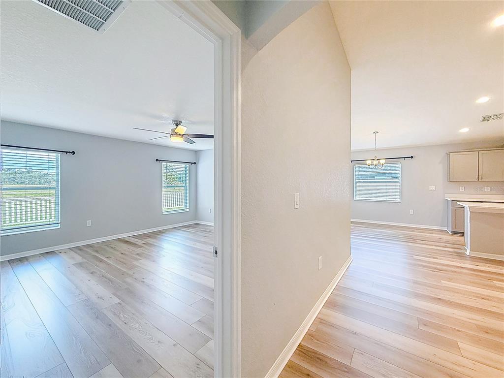 6945 Gideon Circle Zephyrhills, FL 33541 - Photo 28 of 45 wooden floor in an empty room with a window