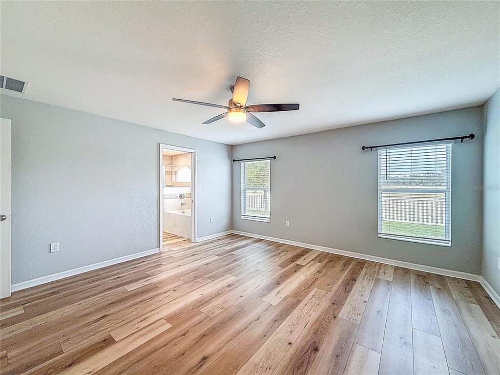 6945 Gideon Circle Zephyrhills, FL 33541 - Photo 30 of 45 a view of an empty room with a window and wooden floor