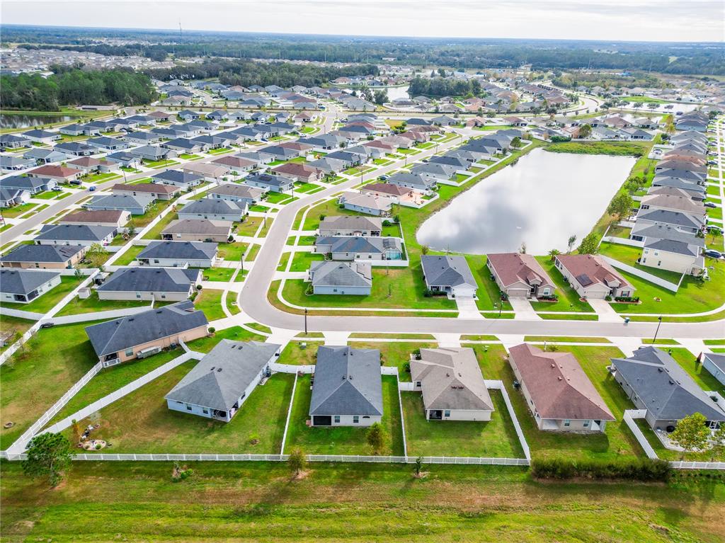 6945 Gideon Circle Zephyrhills, FL 33541 - Photo 44 of 45 an aerial view of residential houses with outdoor space