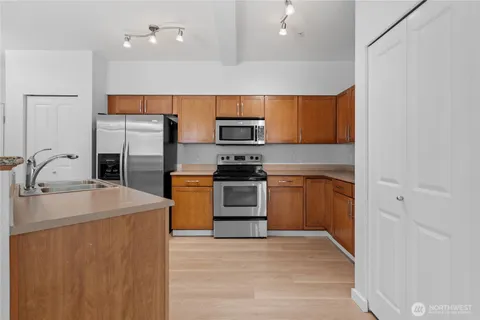 a kitchen with a sink a stove and refrigerator