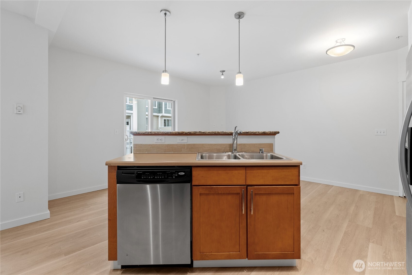 2840 Southwest Raymond Street, Unit 203 Seattle, WA 98126 - Photo 15 of 39 a kitchen with a sink a stove cabinets and wooden floor