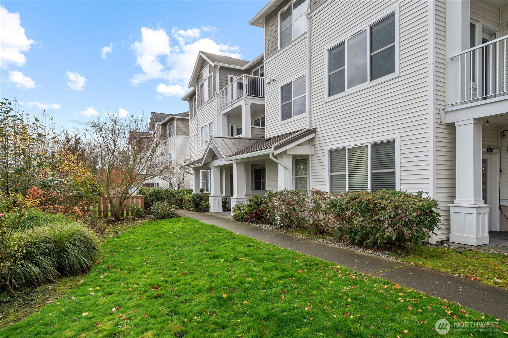 2840 Southwest Raymond Street, Unit 203 Seattle, WA 98126 - Photo 27 of 39 a front view of a house with a yard