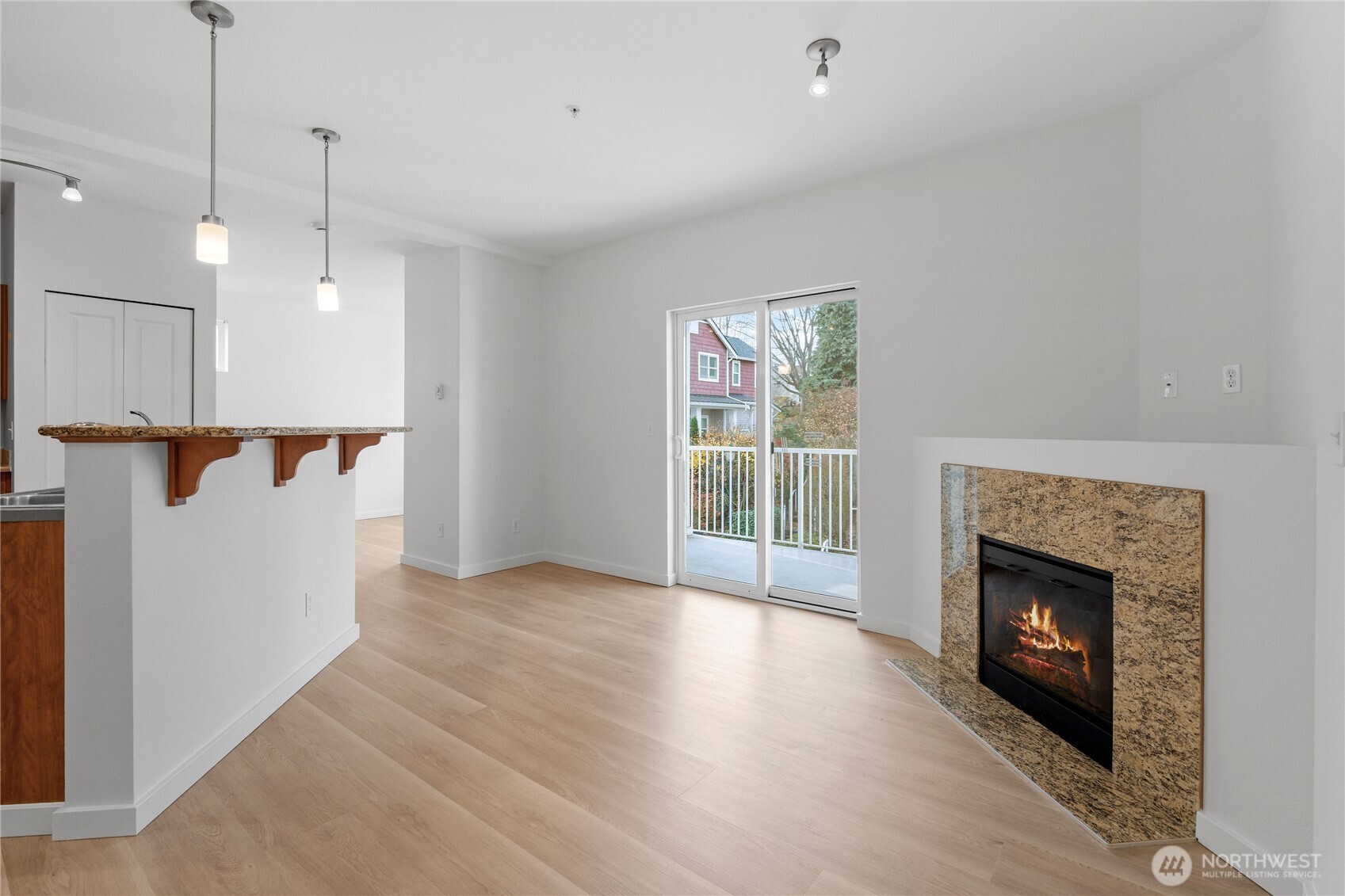 2840 Southwest Raymond Street, Unit 203 Seattle, WA 98126 - Photo 7 of 39 a view of a room with wooden floor and a fireplace