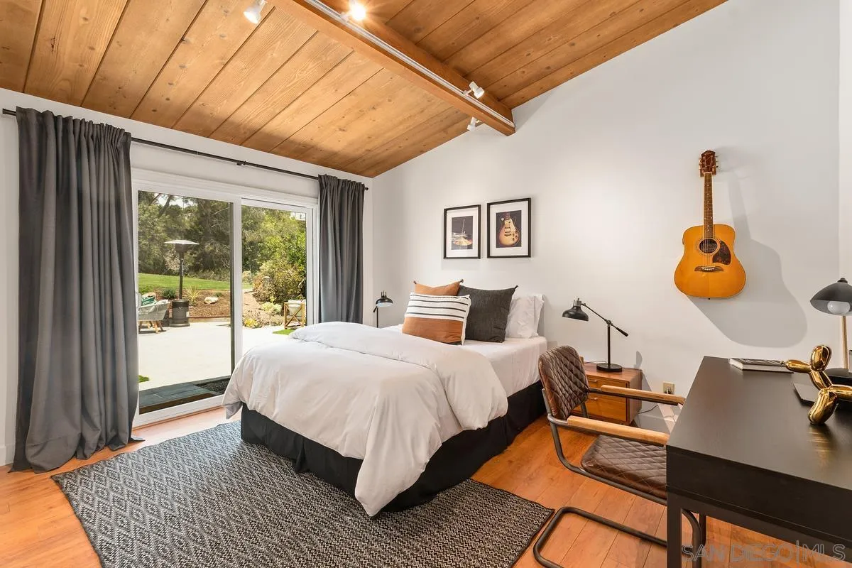 465 Glencrest Drive Solana Beach, CA 92075 - Photo 16 of 28 a bedroom with a bed and wooden floor