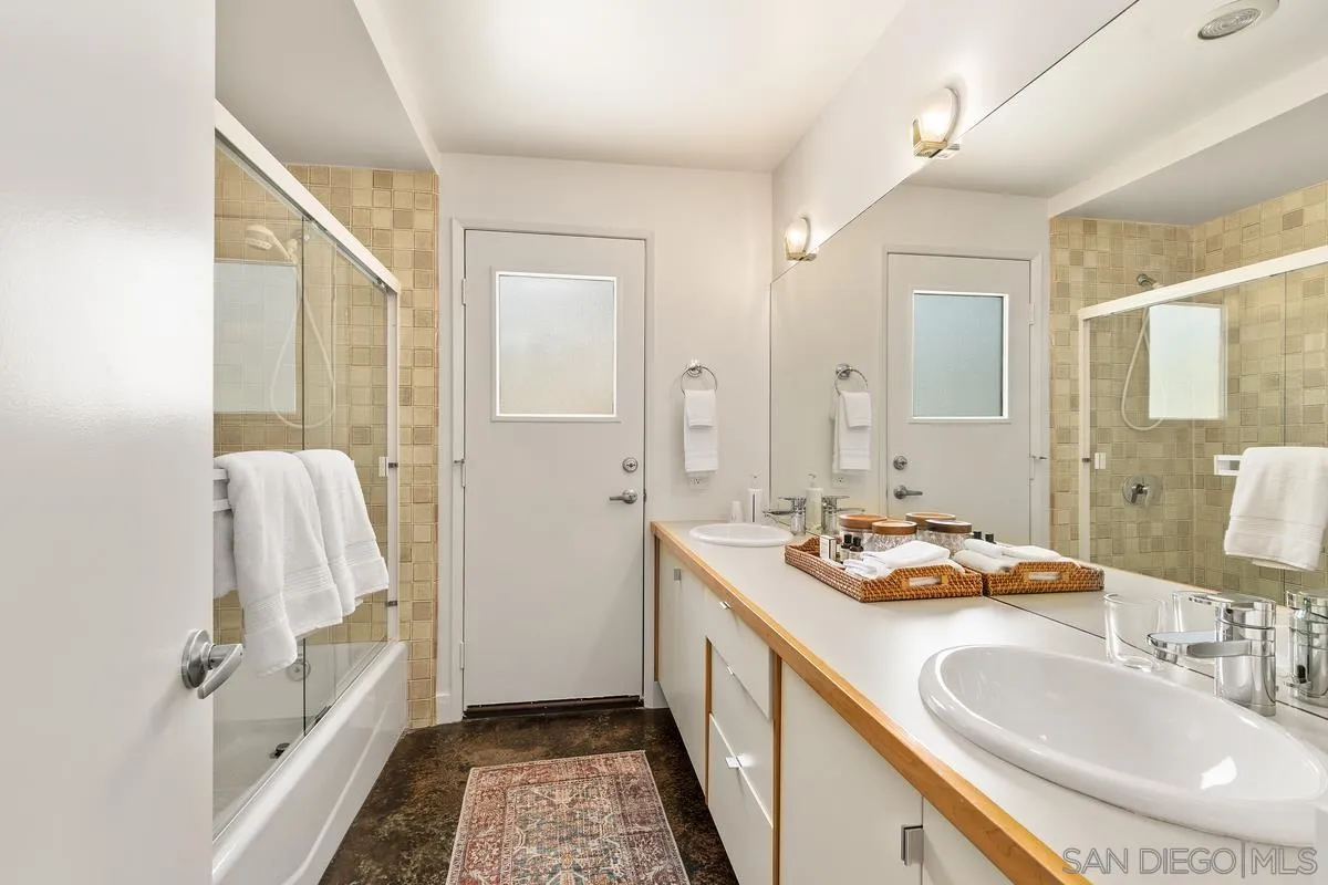 465 Glencrest Drive Solana Beach, CA 92075 - Photo 17 of 28 a bathroom with a sink a mirror and a shower
