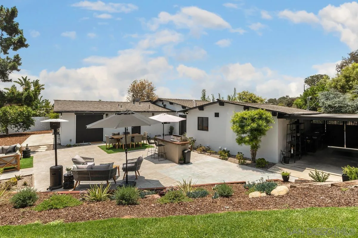 465 Glencrest Drive Solana Beach, CA 92075 - Photo 27 of 28 a view of a patio with table and chairs potted plants and palm tree