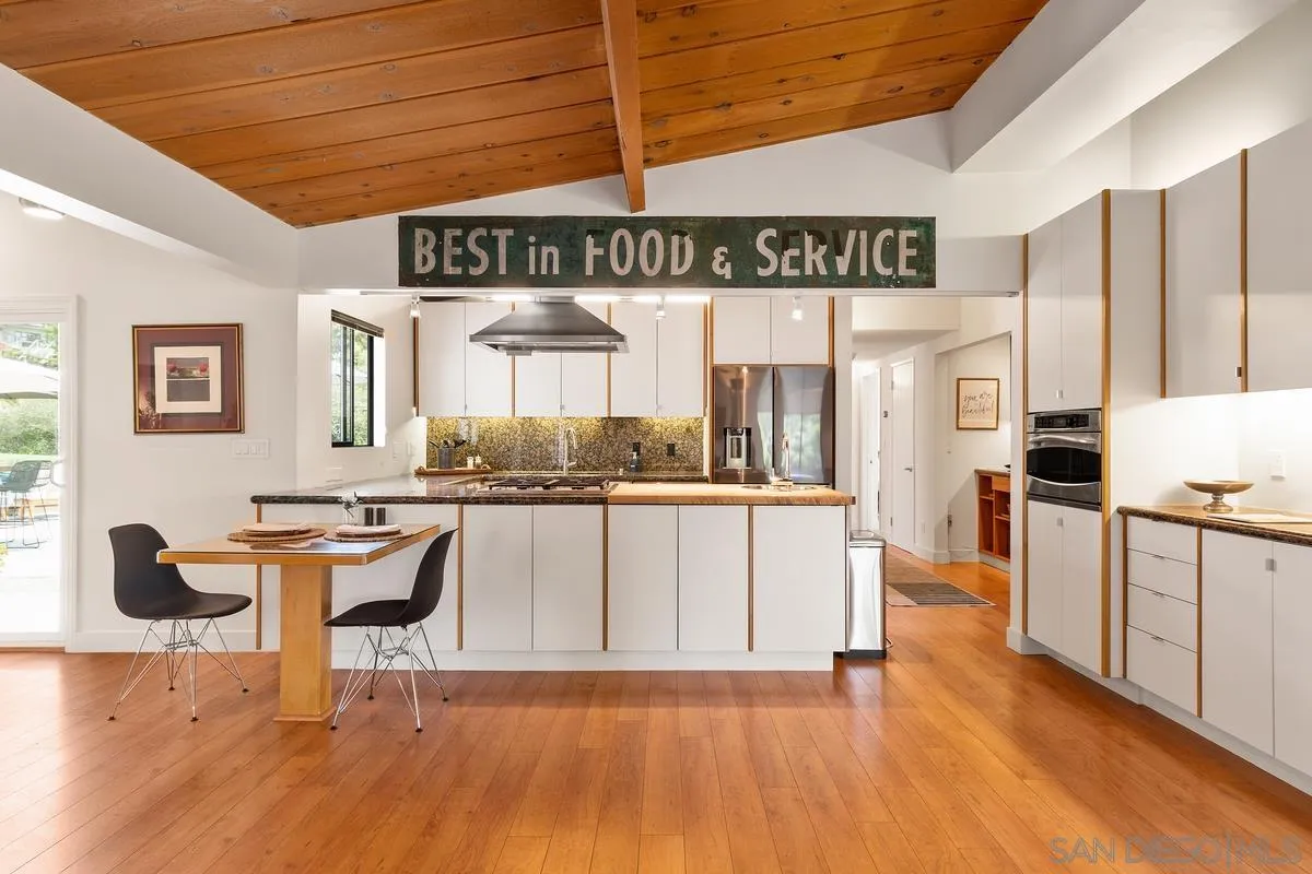 465 Glencrest Drive Solana Beach, CA 92075 - Photo 10 of 28 a kitchen with stainless steel appliances granite countertop a stove a sink dishwasher and white cabinets with wooden floor